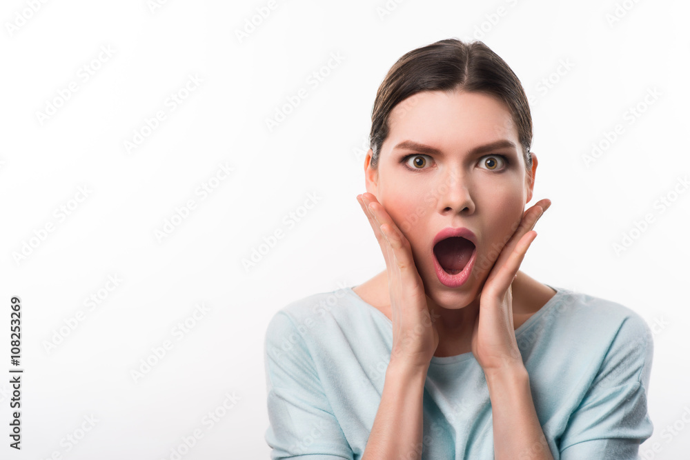 Astonished girl standing isolated on white background