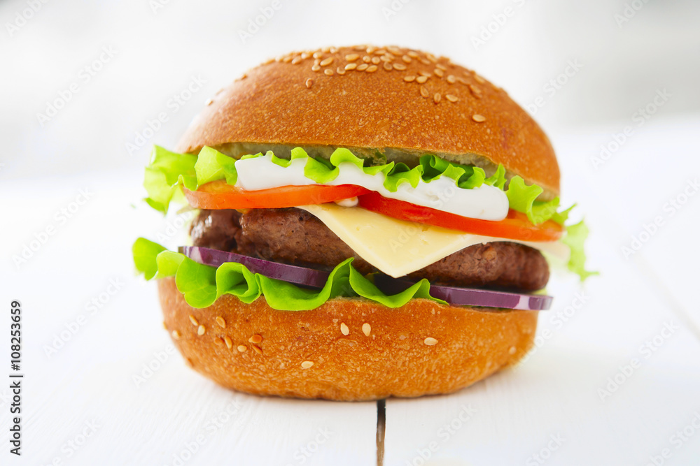 Tasty hamburger on the wooden table. Tasty hamburger on the wooden table.