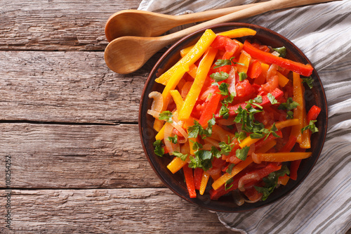 Fototapeta Naklejka Na Ścianę i Meble -  Stewed peppers with tomatoes and onions close up. horizontal top view
