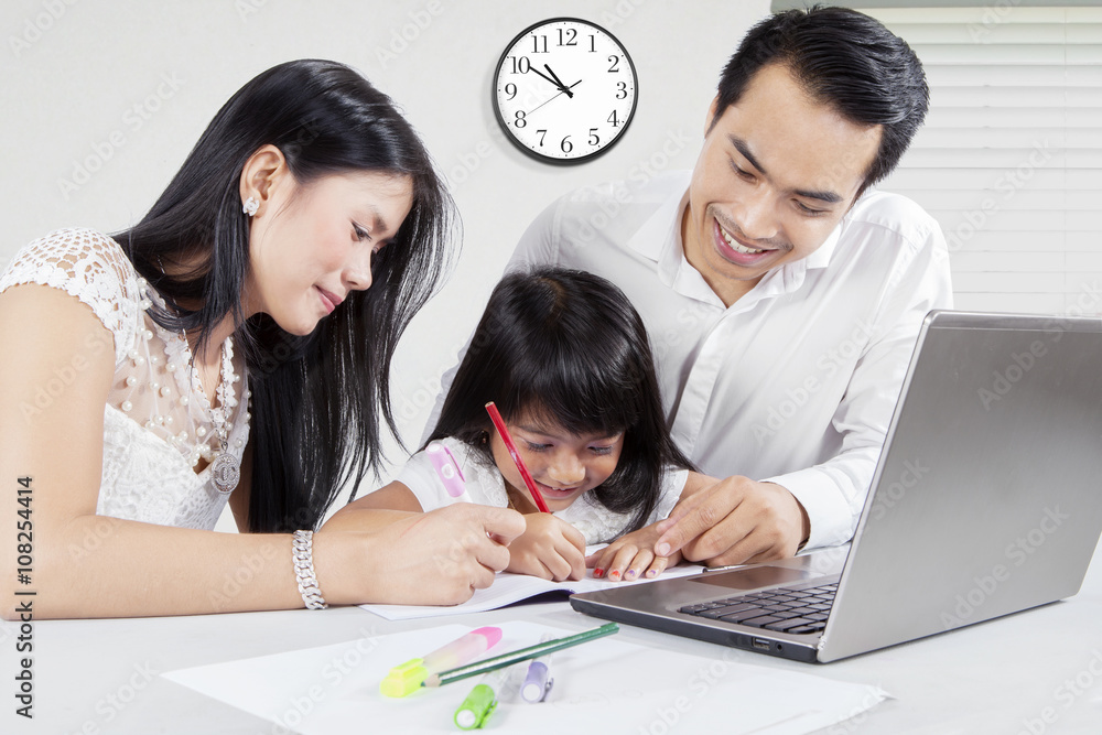 Man and his wife teach their daughter