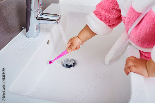 Fototapeta Naklejka Na Ścianę i Meble -  Child hand with toothbrush