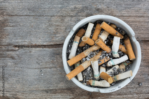 cigarette stub in ashtray photo