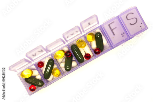 Different pills, medications, the pills in the box for drugs closeup on white background. photo