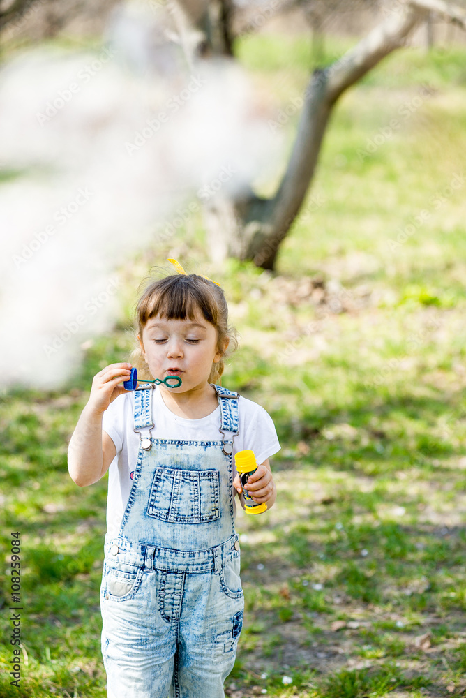 little girl inflates soap bubbles little girl inflates soap bubbles