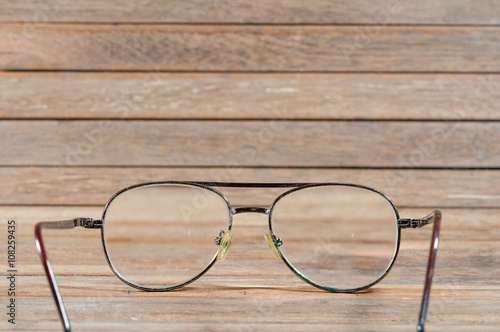 Glasses on wooden texture.