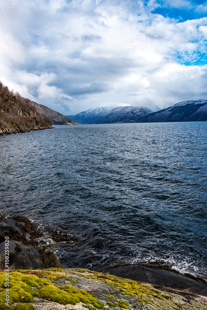 Sea and mountain landscape in Norway. Vertical composition