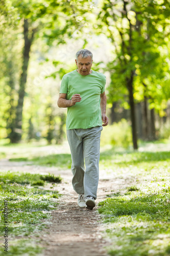 Senior man is jogging in park. Active retirement.