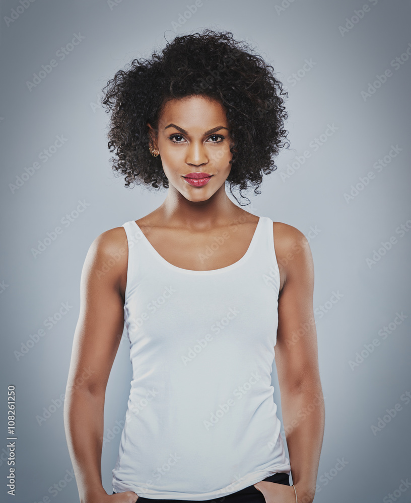 Pretty grinning woman with thumbs in pockets Pretty grinning woman with thumbs in pockets
