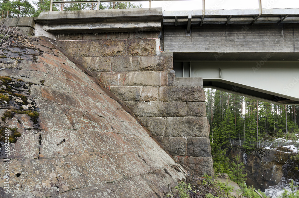 Steel construction and the old stone construction joined together on a Railway bridge in the North of Sweden. Steel construction and the old stone construction joined together on a Railway bridge in the North of Sweden.