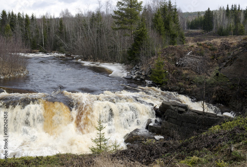 Little river with a waterfall short after the thaw,from the North of Sweden.