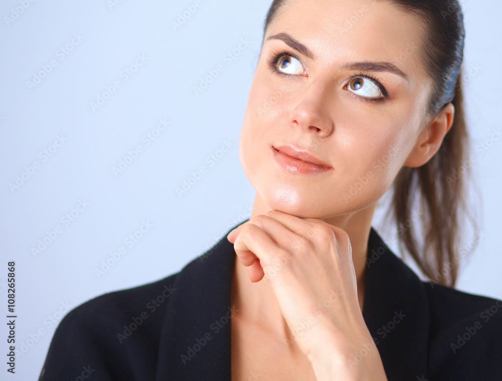 Young woman standing, isolated on gray background Young woman standing, isolated on gray background