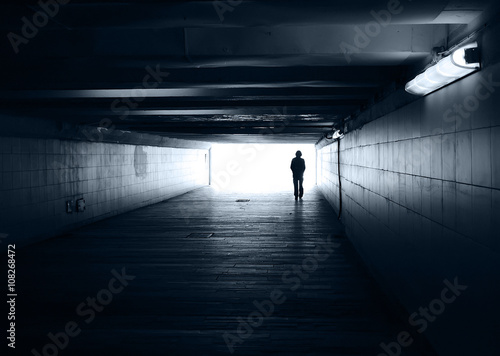 Lonely silhouette in a subway tunnel