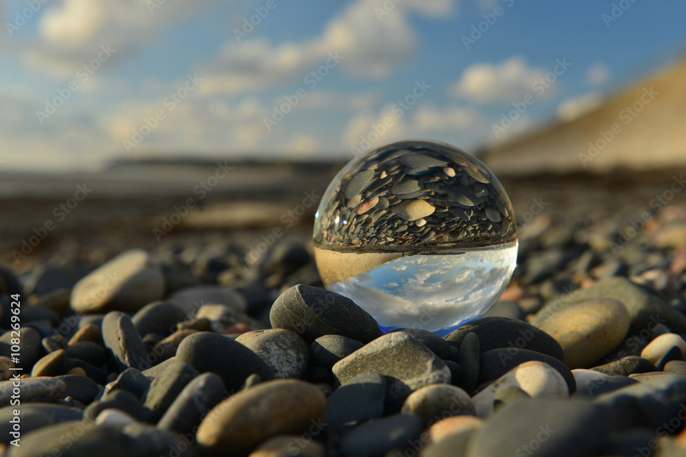 Beach ball, U.K. A crystal ball on a beach. - obrazy, fototapety, plakaty 