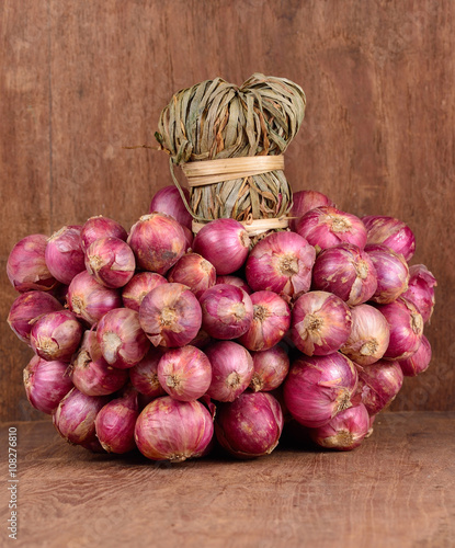 Shallot isolated on wooden background.