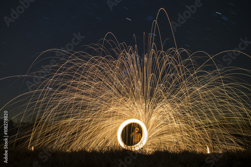 Burning steel wool. Showers of glowing sparks from spinning steel wool