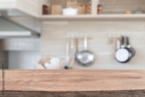 Wood table top with blur kitchen background ,