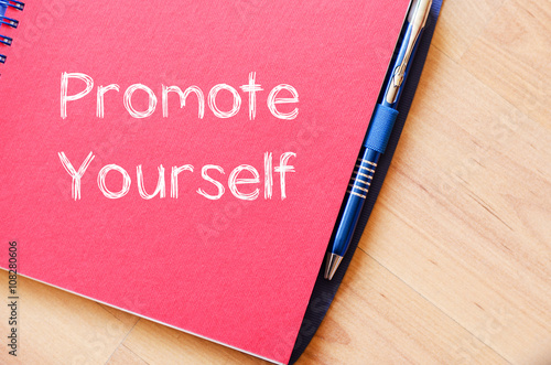 Promote yourself write on notebook