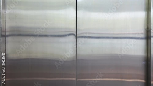 close-up on the elevator door open and close in a hallway