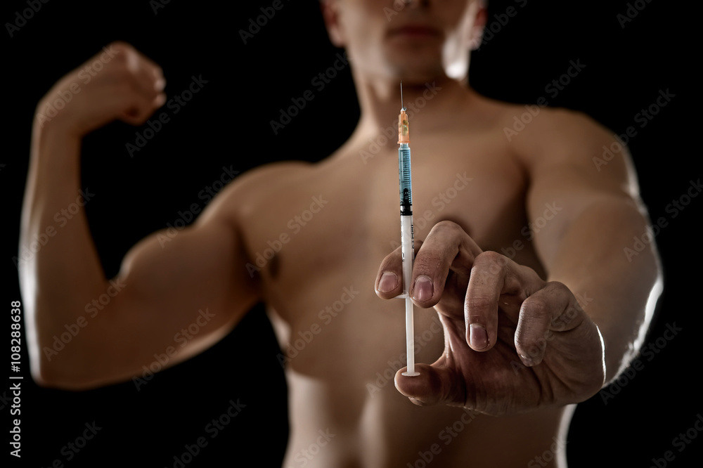 young athletic sportsman holding syringe in sport doping and cheat concept - obrazy, fototapety, plakaty 