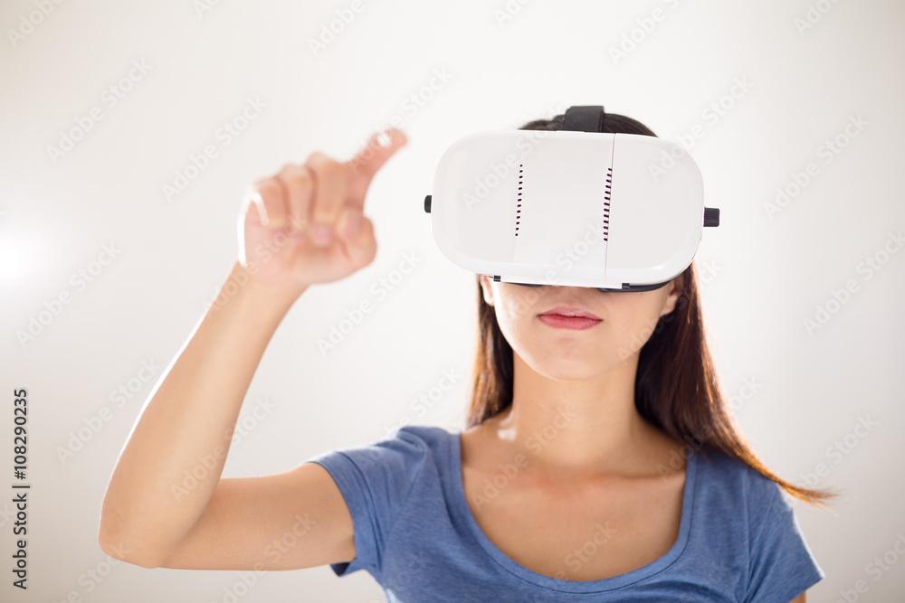 Asian woman using virtual reality device and finger want to touc