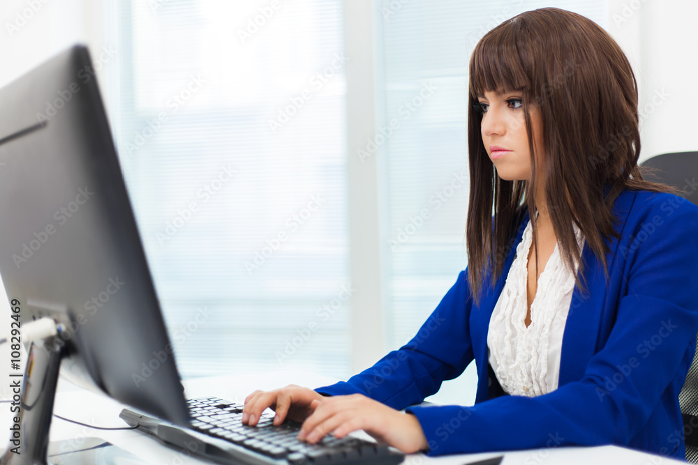Businesswoman using a computer in her office Businesswoman using a computer in her office