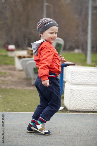 The three-year young boy walking in the spring park
