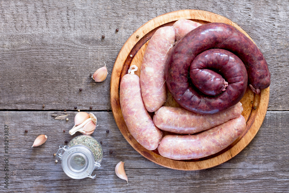 Assortment of meat sausages on dark wooden background, top view. Assortment of meat sausages on dark wooden background, top view.