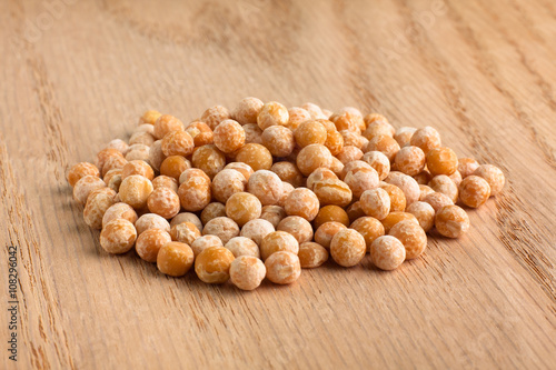 heap of dried peas on wooden background
