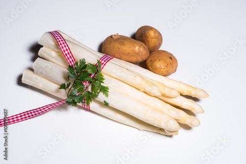fresh white asparagus with checkered red white rope