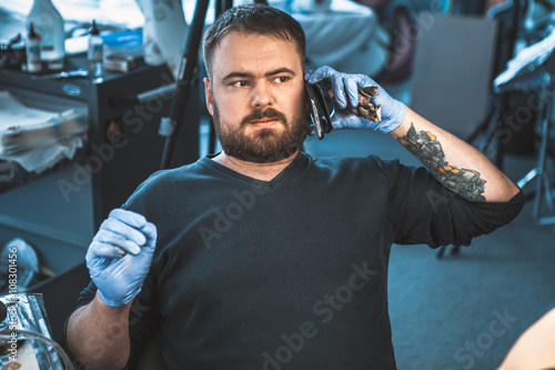 master tattoo artist prepares tools for tattooing