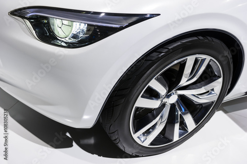 Car headlight and wheel with silver disk of comfortable sport sedan with white bodywork, luxury class vehicle © antonmatveev