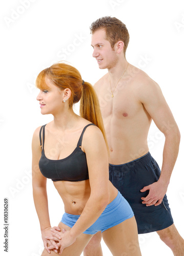 Beautiful young woman and man doing stretching exercises