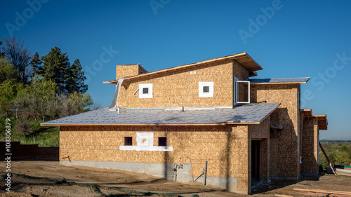 Home under construction near a forest