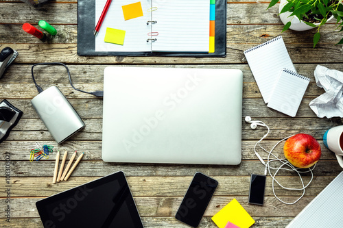 Laptop with other modern electonic devices on desk