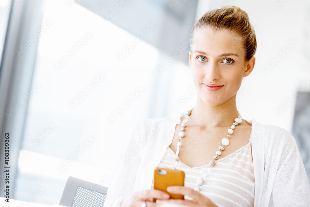 Attractive office worker sitting at desk Attractive office worker sitting at desk