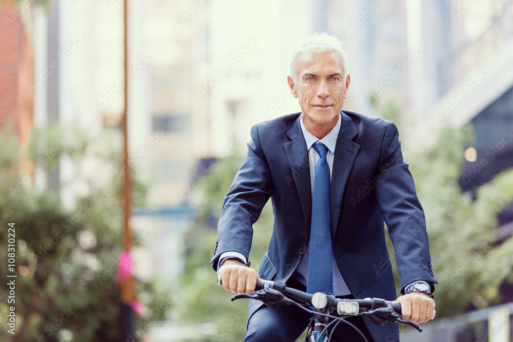 Fototapeta premium Successful businessman riding bicycle