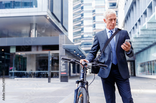 Successful businessman on bicycle with mobile phone © Sergey Nivens