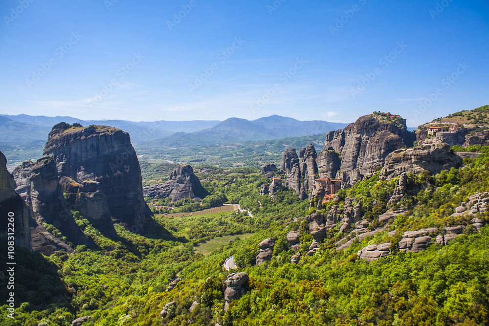 Obraz premium Meteora, Greece. Mountain scenery with Meteora rocks, landscape place of monasteries on the rock, orthodox religious greek landmark in Thessaly. Beautiful landscape in summer day.