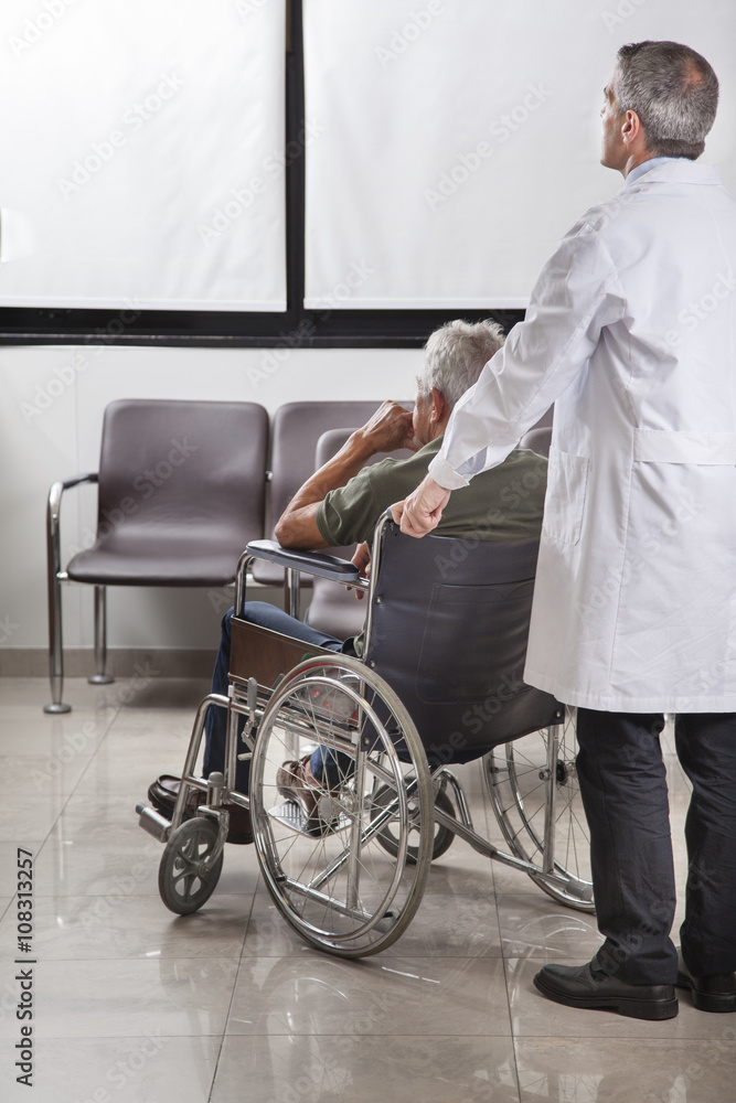 Doctor consulting with a patient in a wheelchair Doctor consulting with a patient in a wheelchair