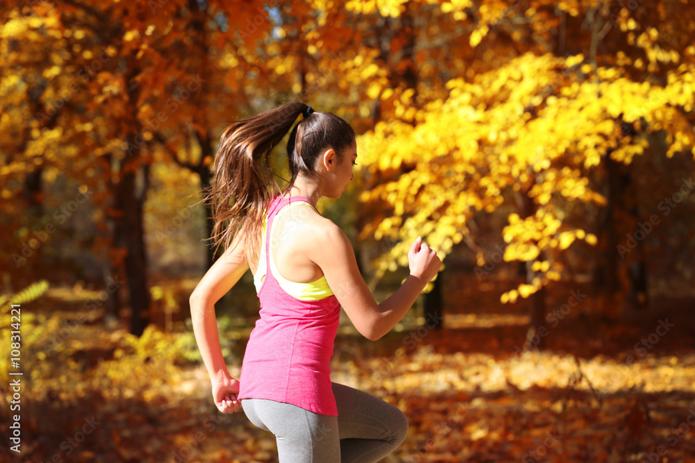Young beautiful woman jogging in autumn park Young beautiful woman jogging in autumn park