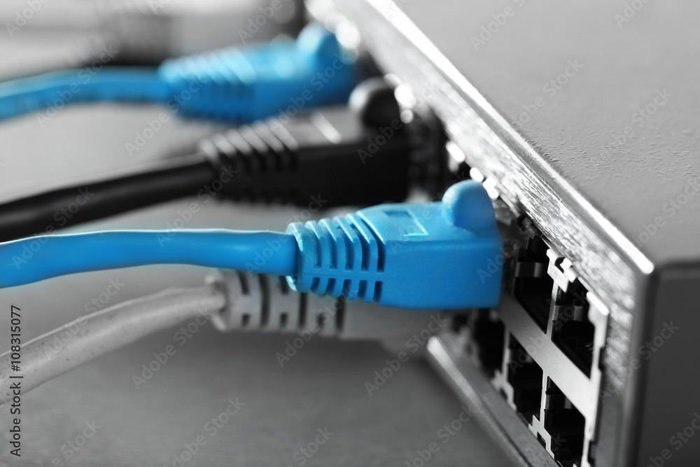 Ethernet cables connected to network switch, close up Ethernet cables connected to network switch, close up