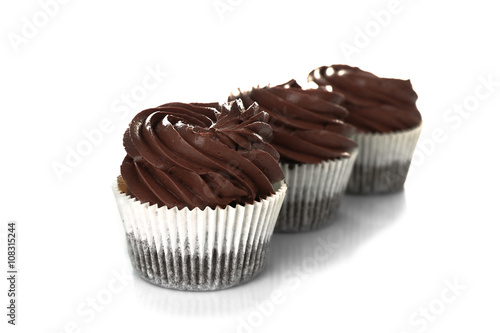 Three chocolate cupcakes  isolated on white