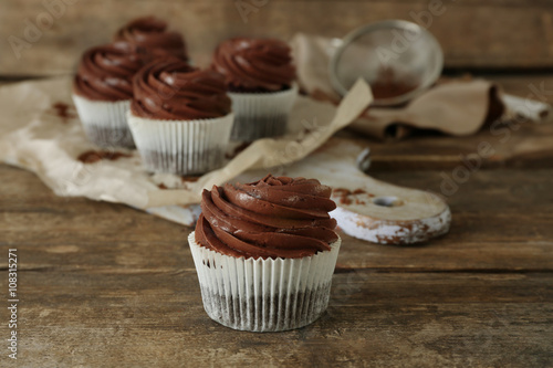 Chocolate cupcake on wooden background, close up