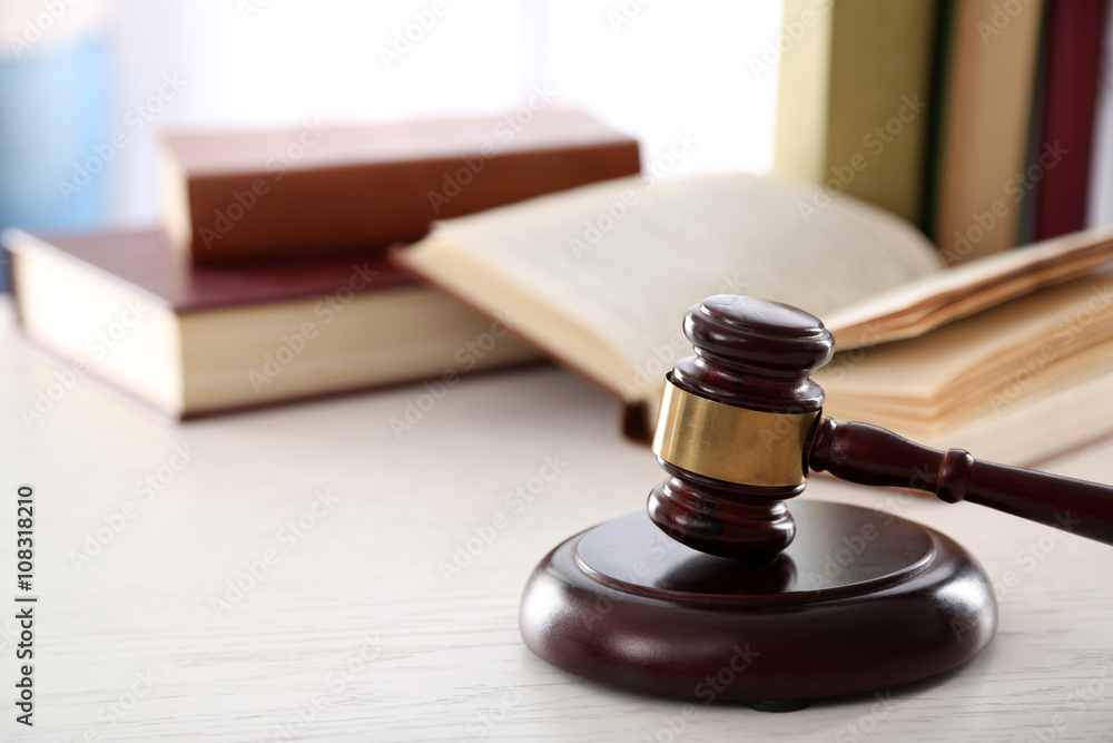 Gavel with books on wooden table closeup Gavel with books on wooden table closeup