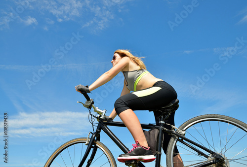 Girl on bike in sunny day.