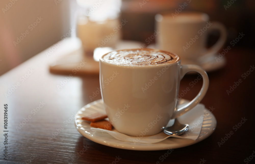Cup of cappuccino on table in cafe Cup of cappuccino on table in cafe