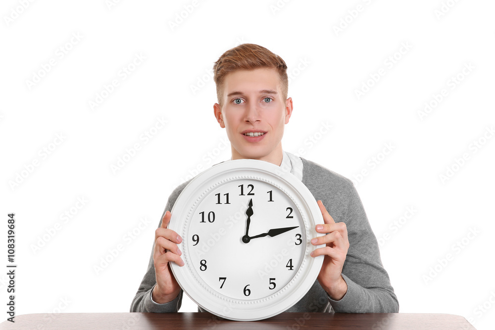 Handsome young man holding clock, isolated on white Handsome young man holding clock, isolated on white