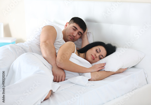 Lovely couple sleeping in white bed