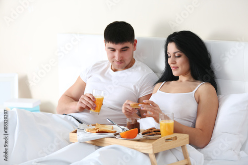 Lovely couple having breakf...