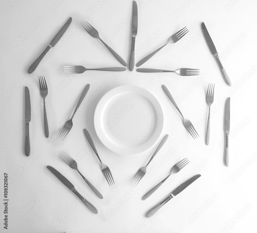 Plate, silver forks and knives, top view Plate, silver forks and knives, top view